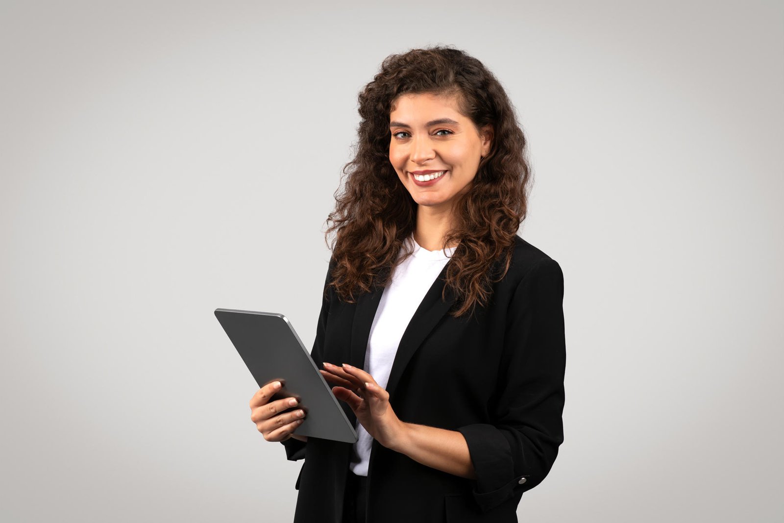 smiling-professional-businesswoman-holding-tablet-2025-03-18-16-17-10-utc.jpg